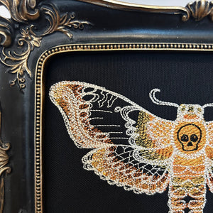 Death Head Moth lace embroidery art framed in a distressed gold and black vintage gothic picture frame.