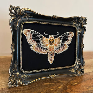 Death Head Moth lace embroidery art framed in a distressed gold and black vintage gothic picture frame.