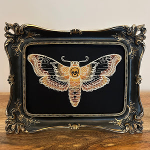 Death Head Moth lace embroidery art framed in a distressed gold and black vintage gothic picture frame.