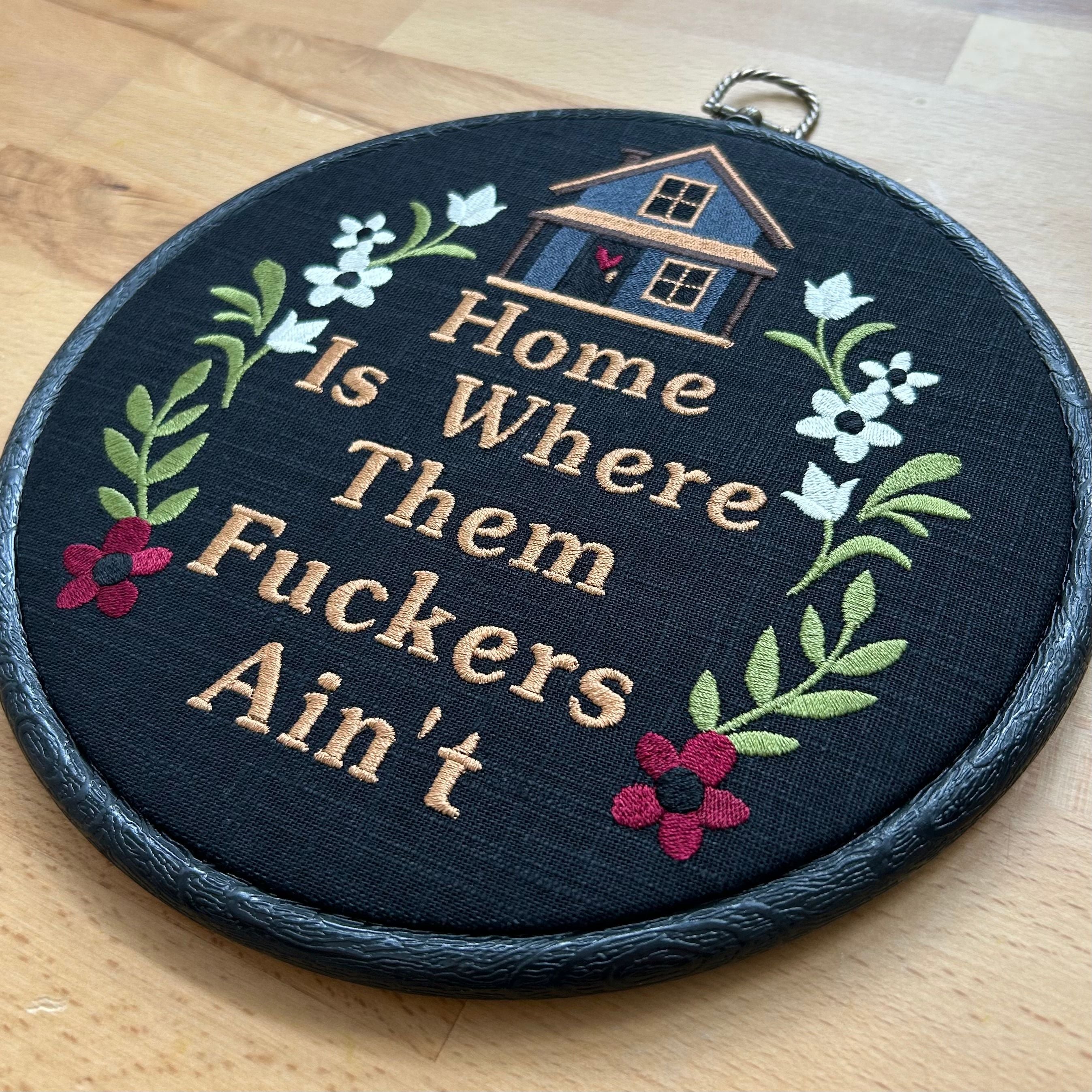 Funny embroidered hoop wall art with floral design and cozy house, featuring a humorous quote about home and peace. Handmade rustic gift for modern farmhouse or quirky decor.