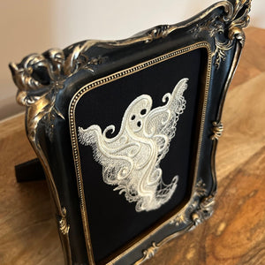 White lace Ghost embroidery art framed in a distressed gold and black vintage gothic picture frame.