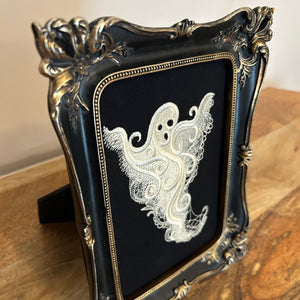 White lace Ghost embroidery art framed in a distressed gold and black vintage gothic picture frame.