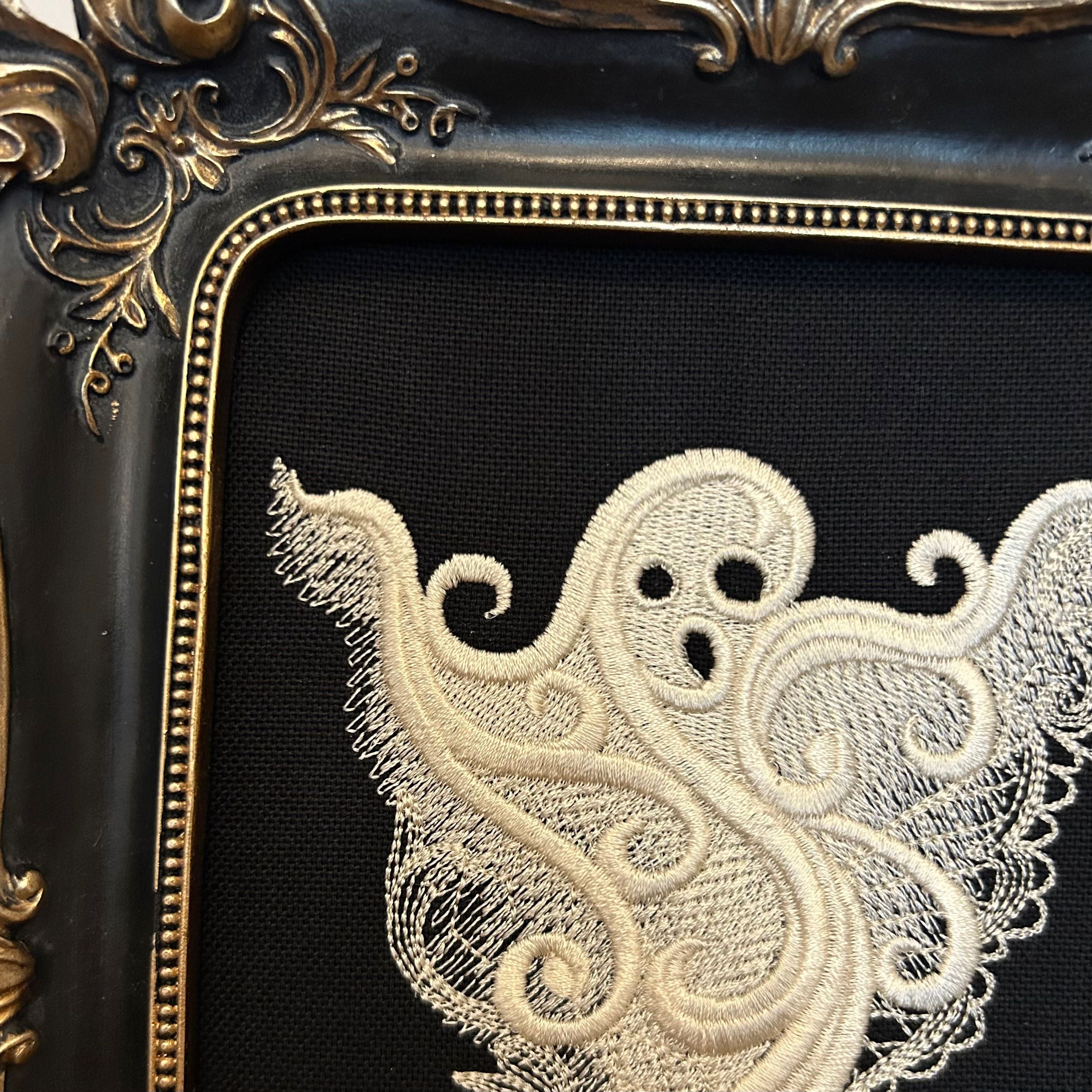 White lace Ghost embroidery art framed in a distressed gold and black vintage gothic picture frame.