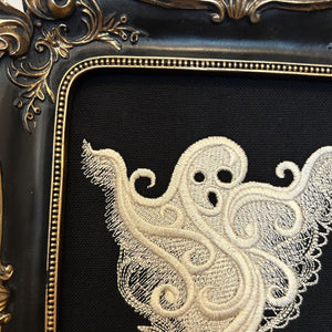 White lace Ghost embroidery art framed in a distressed gold and black vintage gothic picture frame.