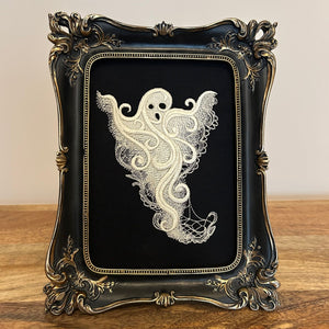 White lace Ghost embroidery art framed in a distressed gold and black vintage gothic picture frame.