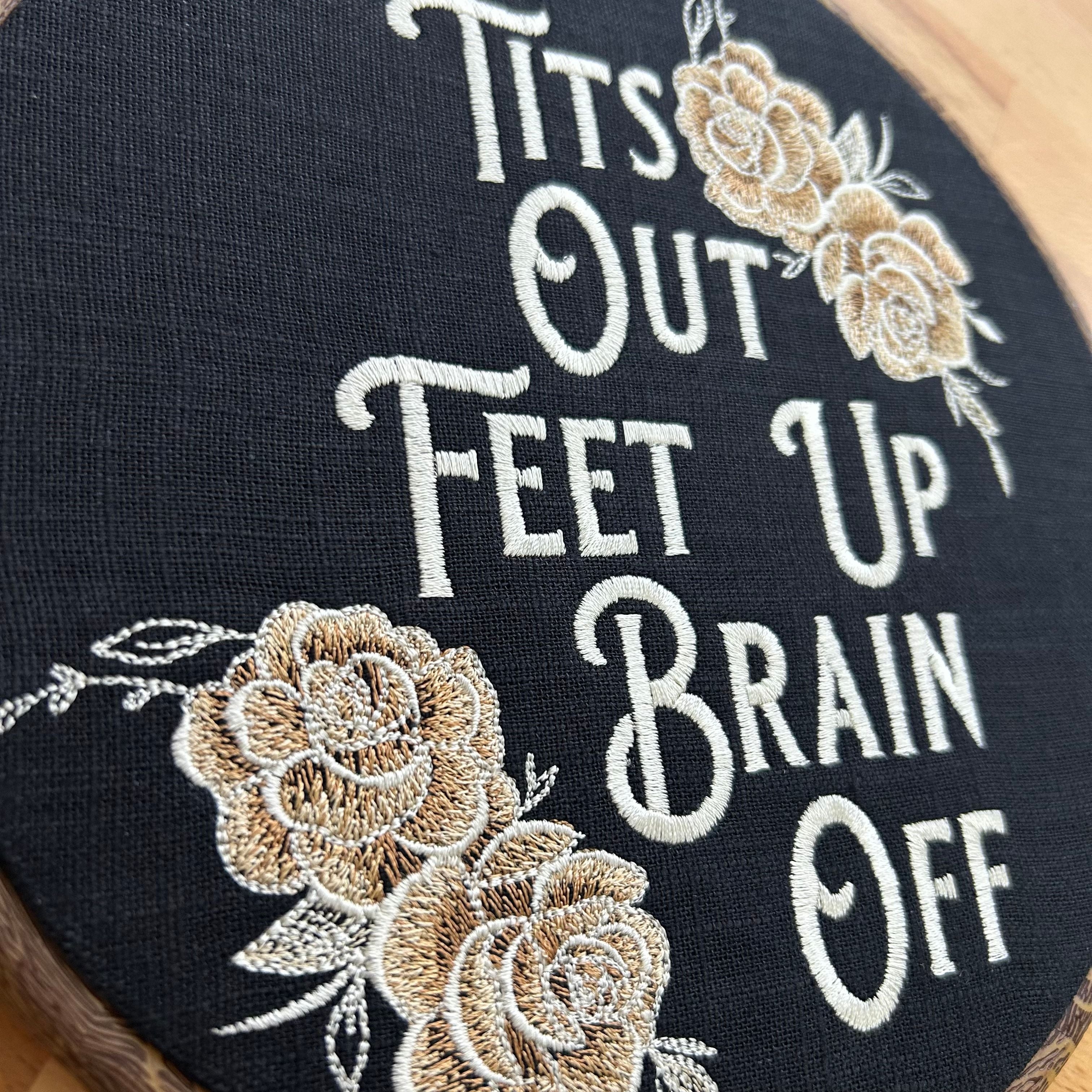 Close up. This stunning wall hanging features gold roses beautifully embroidered onto rich black linen, creating a bold and sassy statement piece. With a wood frame and a perfect blend of vintage charm and modern flair.