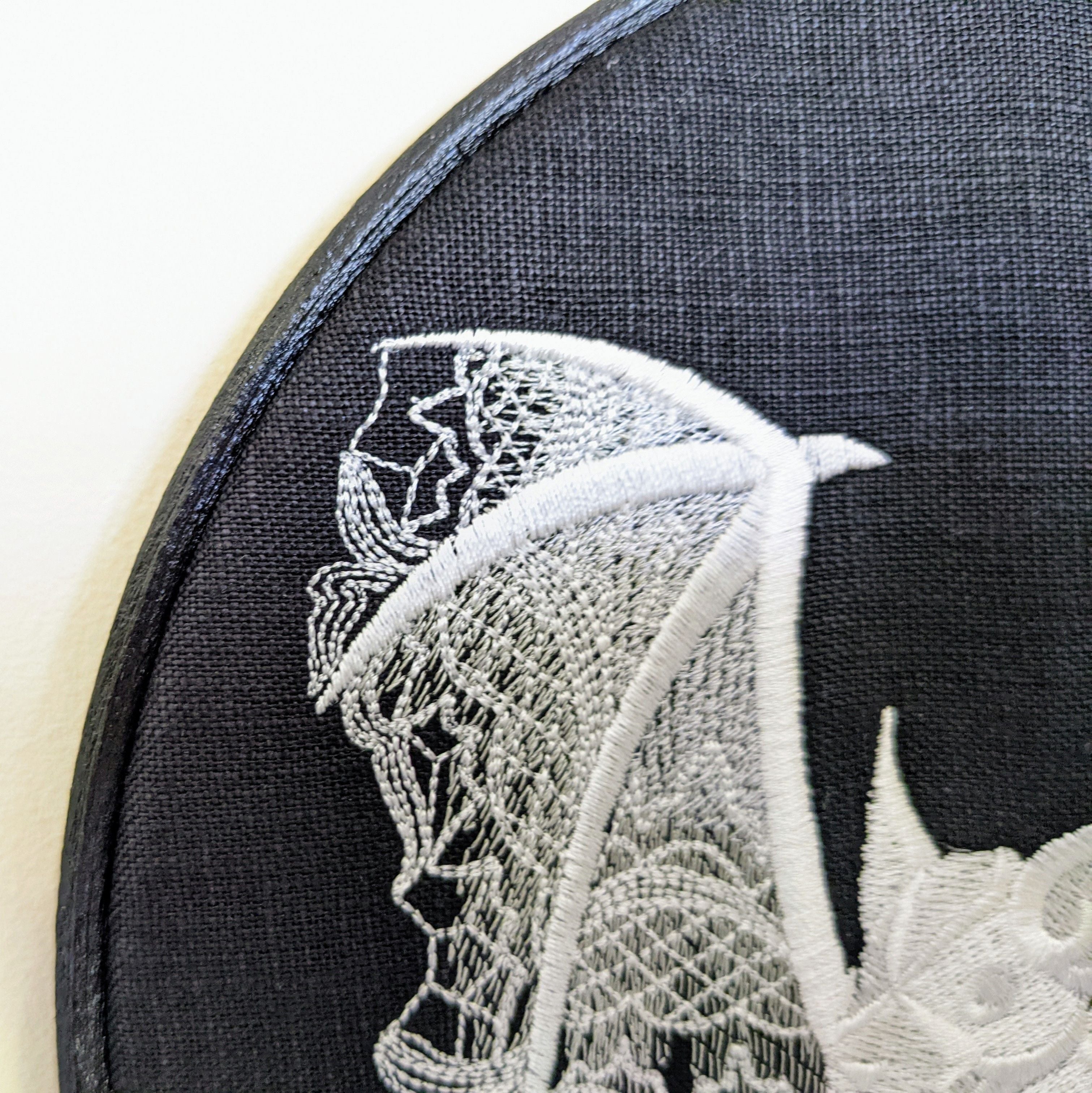 Lace Bat tonal whites onto black linen, Hoop Art, machine embroidered 8" hoop