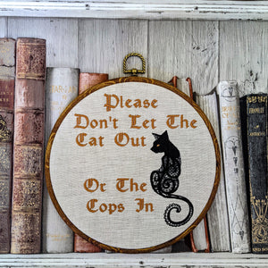 Please don't let the cat out or the cops in. Machine embroidery 8" hoop art