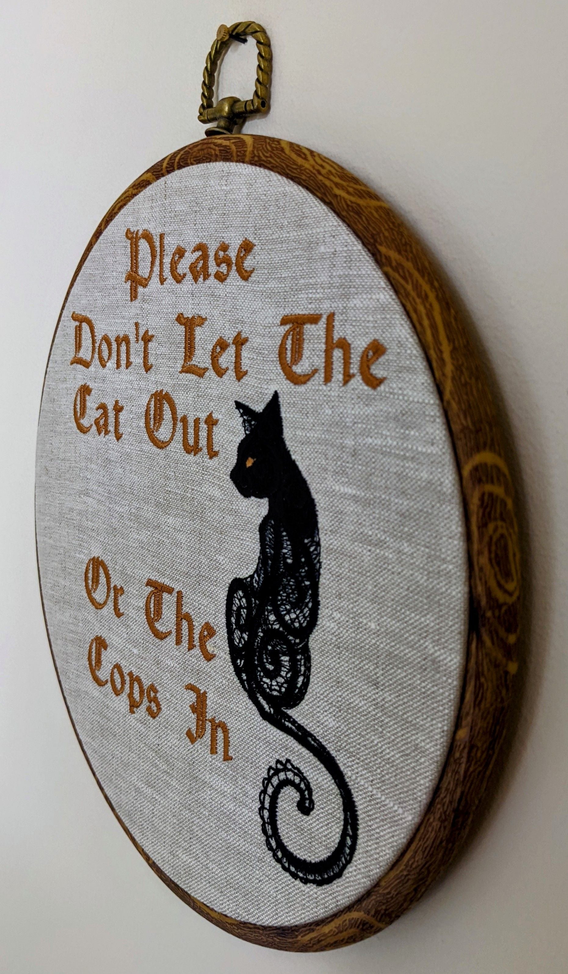 Please don't let the cat out or the cops in. Machine embroidery 8" hoop art