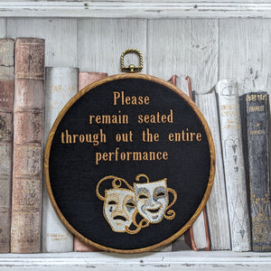 Please remain seated through out the entire performance hoop art. Machine embroidery 8" hoop. Gothic décor, bathroom décor.